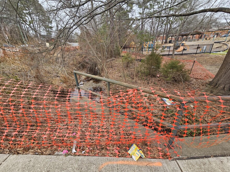 Plastic mesh fencing blocks a contaminated creek next to Burton Park in East Durham
