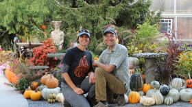 Sherri and Kevin Kukuchka, owners of Creekside Gardens, kneel in front of the entrance of the Pumpkin Walk. The annual event brings hundreds of families to Tunkhannock to see the pumpkin display.