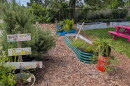 Garden with plants and signs that say "You're so blossom" and "BeeKind" 