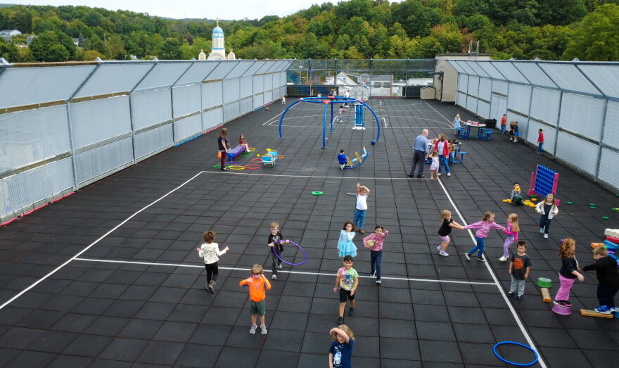 Kindergarten students at St. Clair Elementary school play on the rooftop playground.