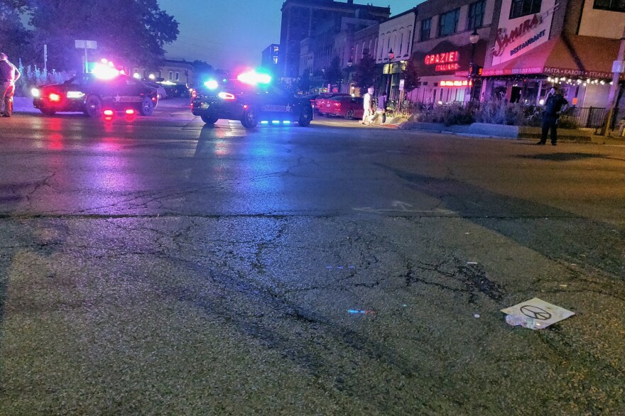 Sheriff's deputies survey the aftermath of a hit-and-run that injured at least one person at a rally against racism in downtown Bloomington.