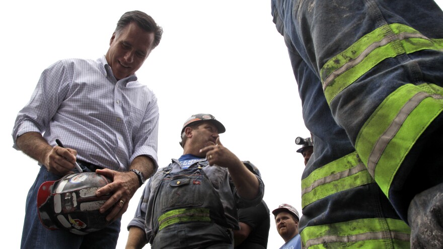 Republican presidential candidate Mitt Romney autographs a coal miner's hat during a campaign event Aug. 14 at American Energy Corp. in Beallsville, Ohio.