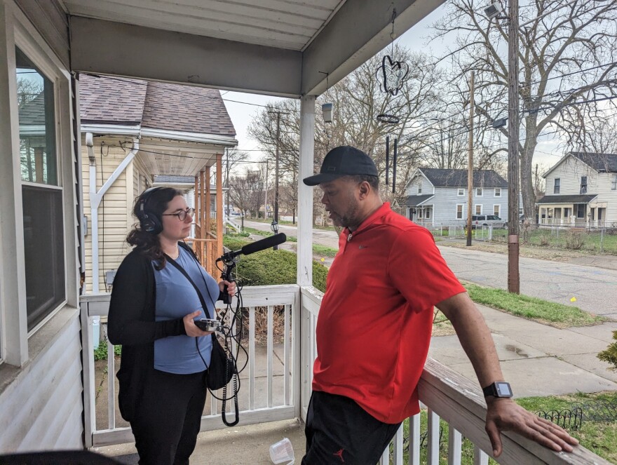 Ideastream Public Media's Taylor Wizner, left, interviews Timothy Davis, about what it was like to wait for an ambulance to arrive with Earl Lewis outside St. Vincent's shuttered ER. "I seen people get shot before. I ain't ever have to help nobody hold the wound or nothing. But, it was just the right thing to do. Common sense tell you, somebody's bleeding, blood anywhere. Hold it and start pressure."