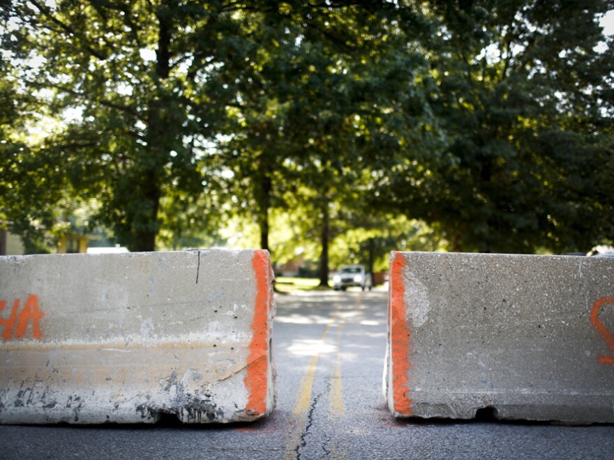 After the police set up barriers in the road, some residents complained that they weren't able to get to their homes. Some cars were seen driving through yards to get around the barriers.