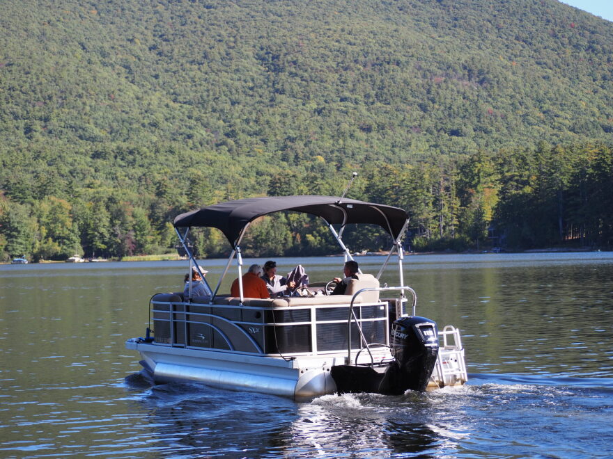 A team of researchers with the UNH Lakes Lay Monitoring Program heads out to track water quality on Lake Kanasatka in Moultonborough Thursday, Sept. 24. At the helm is lakeshore resident Kevin Kelly, who has helped measure water quality on the lake for decades. (NH Bulletin photo)