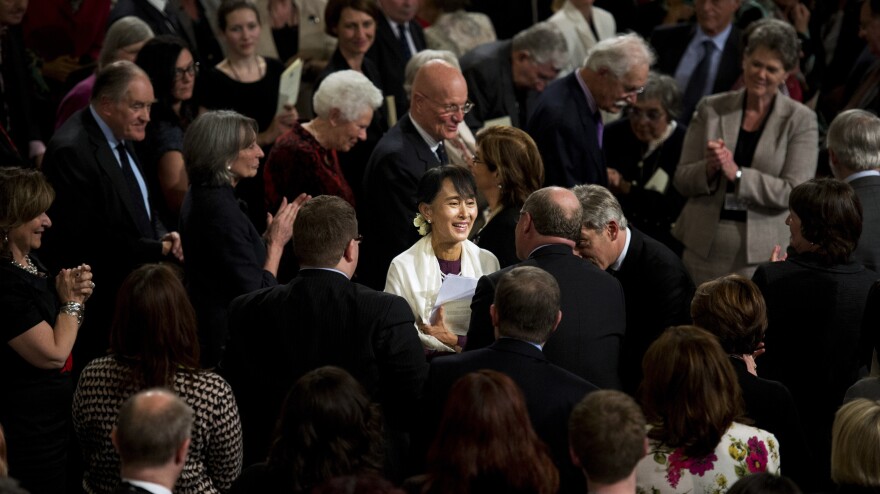 Myanmar opposition leader Aung San Suu Kyi smiles as she leaves Westminster Hall after addressing both Houses of Parliament on June 21 in London.