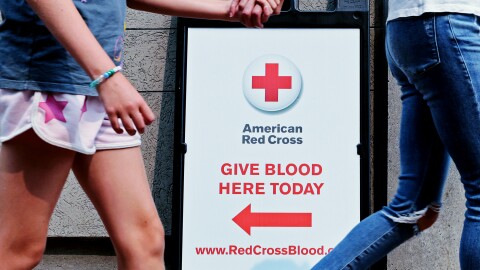 Pedestrians pass the American Red Cross Blood Donation Center on July 14, 2026. Blood donation appointments in Mass. are booked up for weeks. There's still an urgent need for more.