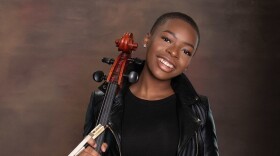 African woman with a short black hair holding her cello