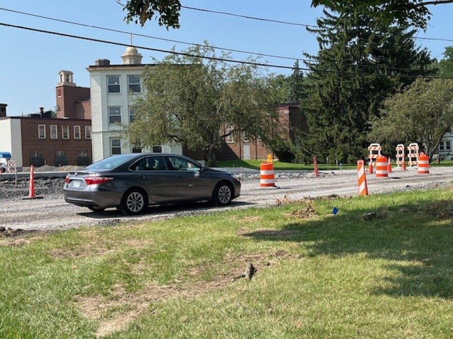A car passes through Loretto's property on the way to Fillmore Ave, which connects to S. Salina St.