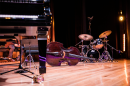 The instruments of a jazz band are set up on a stage. 