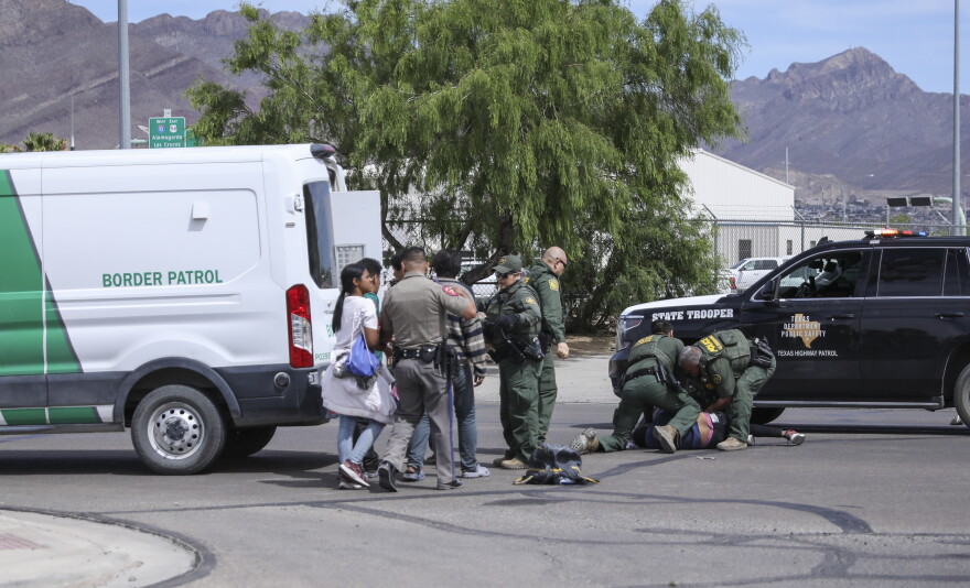 U.S. Border Patrol, El Paso police and Texas Department of Public Safety officers chase a group of migrants in South Central El Paso on May 6. 