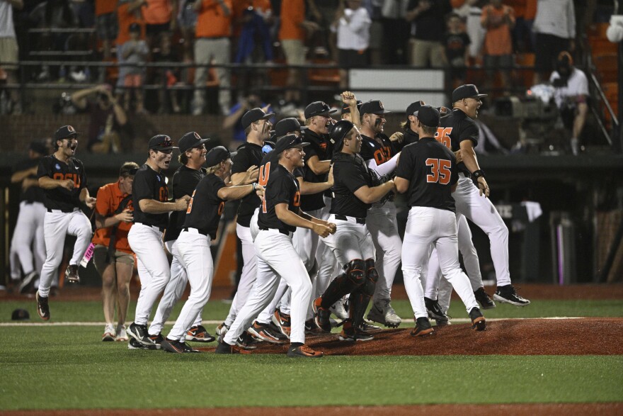 Oregon State Baseball players celebrate on the mound.