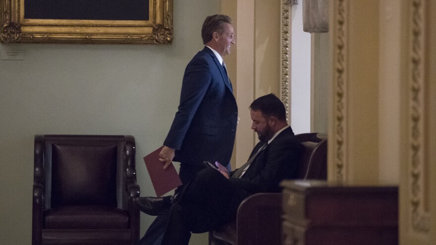 Sen. Jeff Flake, R-Ariz., arrives for a Republican luncheon with President Donald Trump on Oct. 24. Hours later he went to the Senate floor to announce his retirement and denounce "flagrant disregard of truth and decency" in American politics.