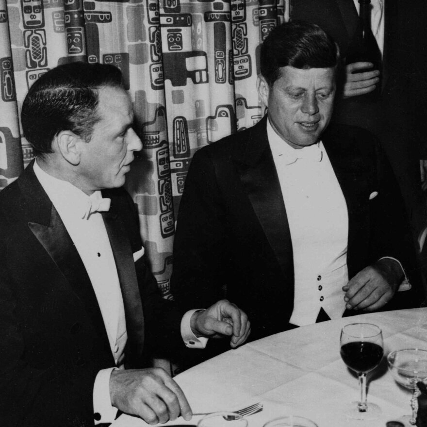 President John F. Kennedy sits with Frank Sinatra at his Inaugural Ball in 1961.