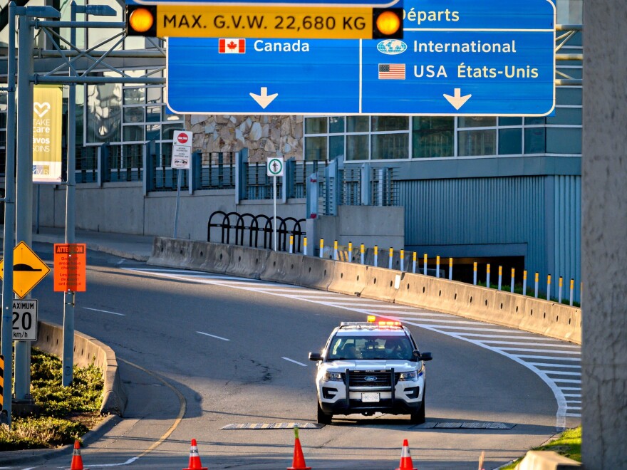 Canada plans to impose a new vaccine mandate on passengers and workers in the federally regulated air, rail and cruise ship sectors. Here, a police car is seen behind traffic cones in May near Vancouver International Airport in British Columbia.