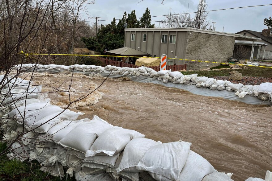 Sandbags divert the overflowing Emigration Creek away from homes near 1700 S in Salt Lake City on April 13, 2023.