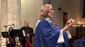 The Rev. Patricia Orlando stands during the Blue Christmas service, talking about the cards that would later be handed out so parishioners could write down their pain and prayers.