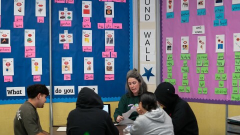 Teacher Katy Reese, center, works with students in a literacy class at Oakland International High School in Oakland on March 7, 2025.