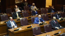 Lawmakers on the House floor for the ceremonial beginning of session were spaced out and wearing masks.