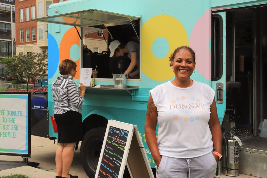 Traci Lukemire standing in front of her Donna's Delicious Dozen food truck.
