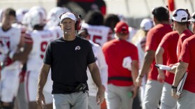 Utah head coach Kyle Whittingham, left, looks at the Jumbotron after a play in the first half of an NCAA college football game against Oklahoma State, Saturday, Sept. 21, 2024, in Stillwater, Okla.