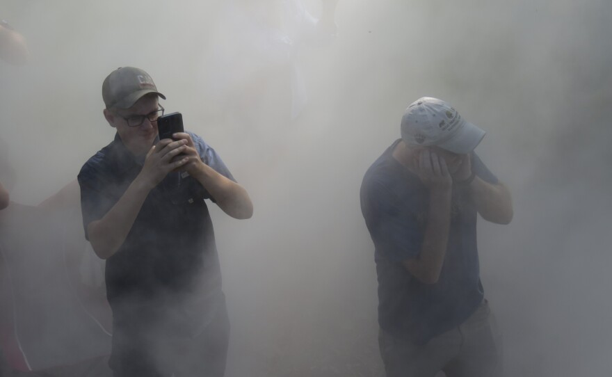 Onlookers are surrounded by steam from Big Boy 4014 outside of Sayre, Pa. on Friday.
