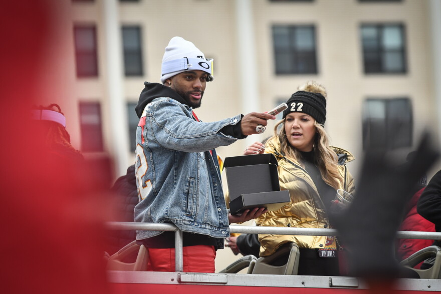 Kansas City Chiefs safety Justin Thornhill passes out cigars during the Super Bowl victory parade on Feb. 15, 2023.