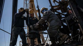 A service rig crew pulls sucker rods from an oil and gas well as they work to bring a downhole pumping unit to the surface on Aug. 14, 2024, in West Odessa.
