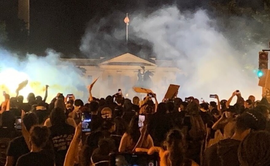 Clouds of tear gas obscure the North Portico of the White House, where protesters in Washington, D.C., gathered Sunday night.