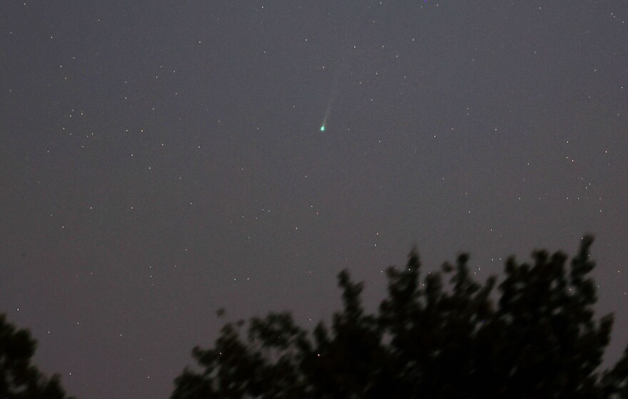  A green-blue comet in the starry night sky