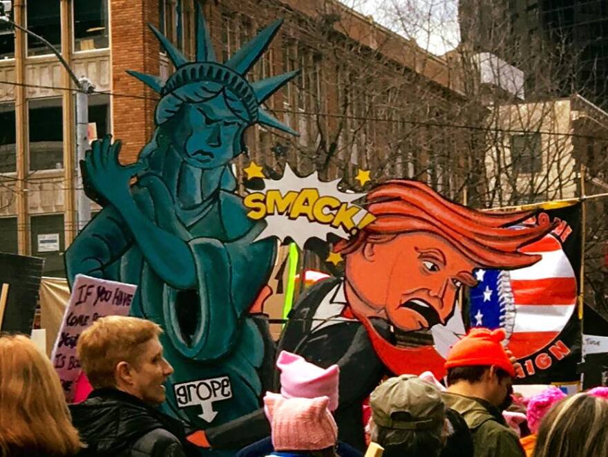 Signs from Saturday's march in Seattle, submitted by Sarah Reames on KUOW's Facebook page.