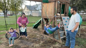 Joe and Alisha Bartleson play with their children on the swing set in their yard in Buffalo, Iowa. They think Donald Trump is the best Republican candidate to take on Joe Biden in 2024.