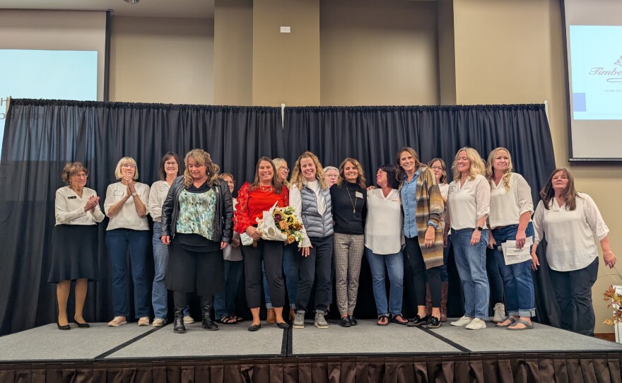 Those representing the Itasca Area Cancer Crisis Fund stand on stage to receive a matching donation from an anonymous donor at the 100+ Women Who Care Itasca Area event on Oct. 13, 2025, at Timberlake Lodge in Grand Rapids.