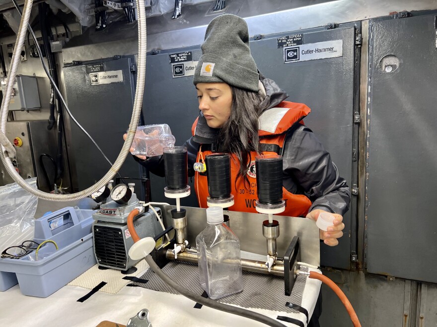  Aliya Jamil, a graduate researcher at Oregon State University, filters water for a phytoplankton experiment.