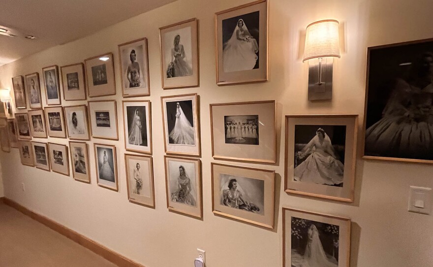 A wall of portraits showing brides through the decades.