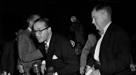 FILE - Dalton Trumbo, left, Hollywood screenwriter, shouts from the witness stand as he tries to make a statement before the House Un-American Activities Committee, Oct. 28, 1947, in Washington. At right is his attorney Robert Kenny. Trumbo was excused from further testimony when he refused to state whether he is or has been a communist. 