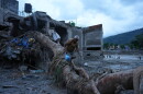 A resident salvages belongings from his damaged home after flash flooding in the Devighat area of Nuwakot district in Nepal, Monday, Aug. 31, 2026.