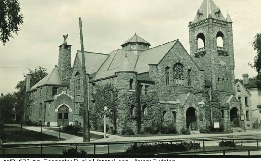 A black and white photo of a red sandstone church