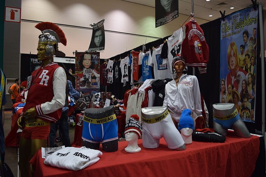 A booth filled with merchandise for Tommy Wiseau and 'The Room'
