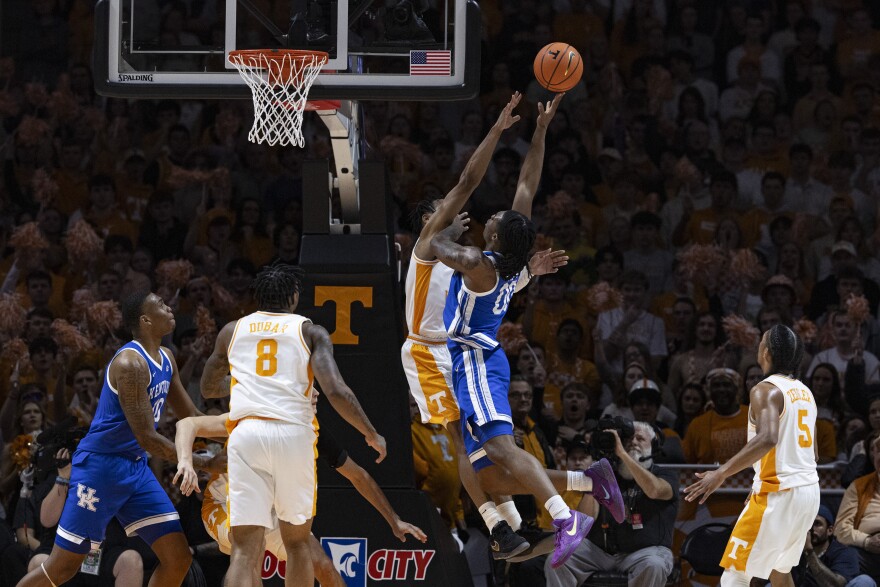 Kentucky guard Otega Oweh (00) shoots as he's fouled by Tennessee guard Jordan Gainey during the first half of an NCAA college basketball game Tuesday, Jan. 28, 2025, in Knoxville, Tenn. (AP Photo/Wade Payne)