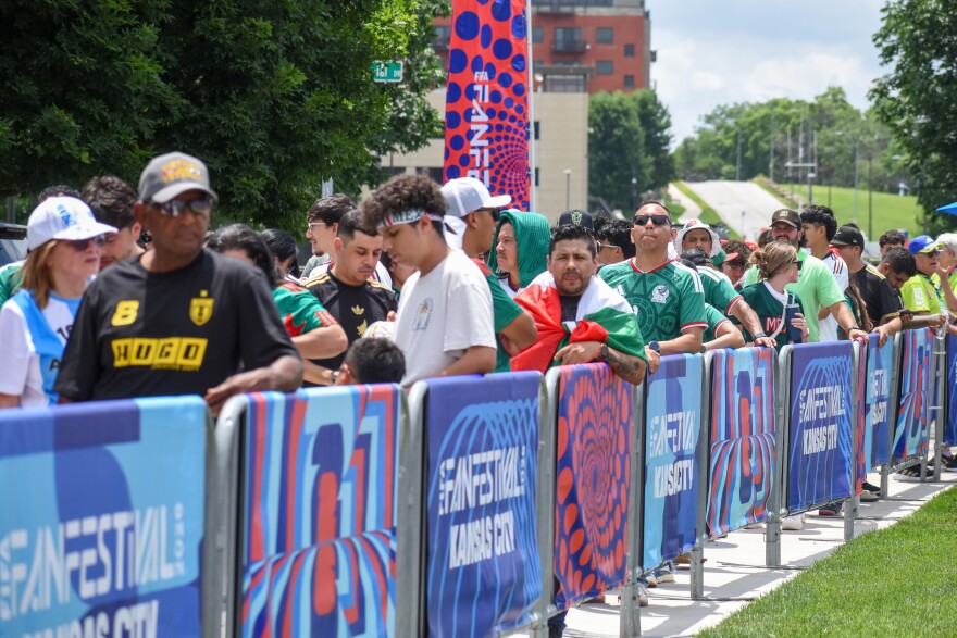 Fans wait near the gate of Kansas City's FIFA Fan Fest on June 11, 2026.