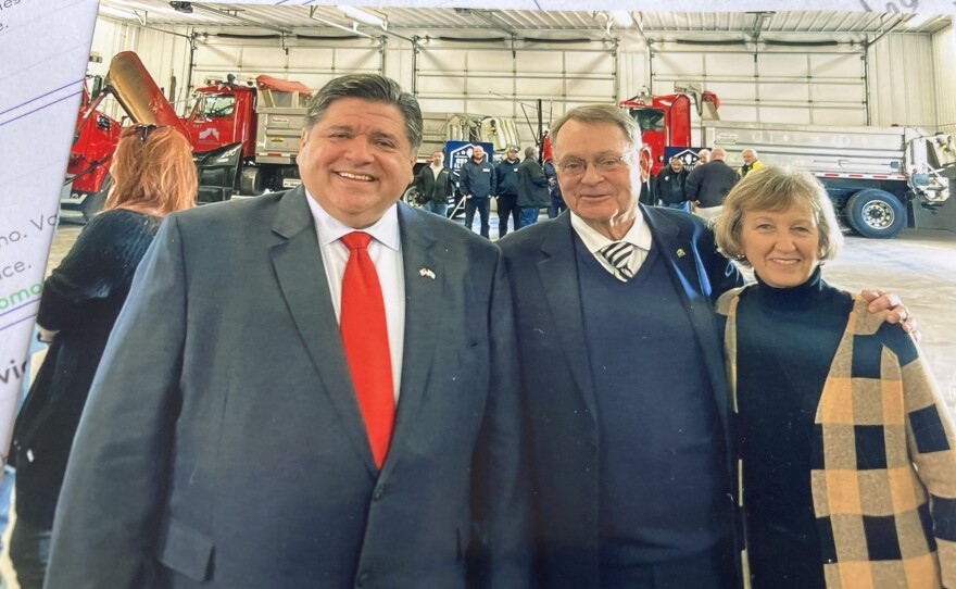 Governor Pritzker stands next to John McIntyre and his wife for a photo.