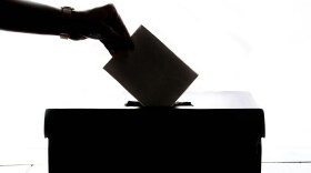 Ballot box with vote being cast image