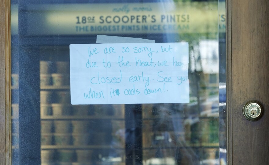 A sign is shown on the door of a Molly Moon's Ice Cream store in Seattle's Capitol Hill neighborhood. The store was closed Monday due to excessive heat.