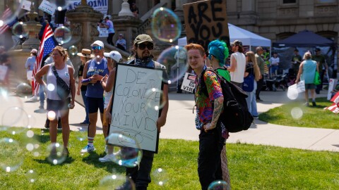 A "No Kings" rally at the Michigan Capitol in Lansing, Mich., on June 14, 2025, featured drag performers, stilt walkers, bubble walls, satirical carnival games and more.
