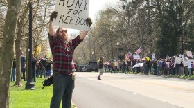 Hundreds of demonstrators gathered at the governor's mansion waiving flags and signs to protest the state's "Stay-At-Home" order.