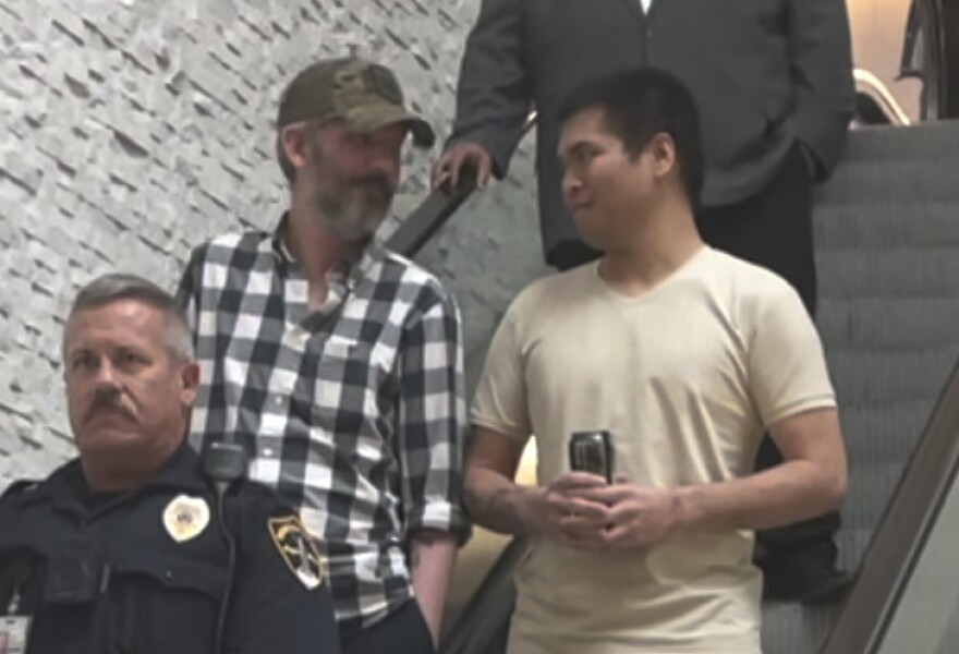 Andy Huynh, left, and Alex Drueke, right, are seen arriving at Birmingham-Shuttlesworth International Airport in Birmingham, Ala., Saturday, Sept. 24, 2022. The U.S. military veterans disappeared three months ago while fighting Russia with Ukrainian forces. They were released earlier this week by Russian-backed separatists as part of a prisoner exchange. (AP Photo/Kim Chandler)