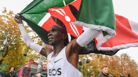 Eliud Kipchoge celebrates breaking the two hour barrier for a marathon distance with supporters and his team on the Hauptallee. (Thomas Lovelock for The INEOS 1:59 Challenge)