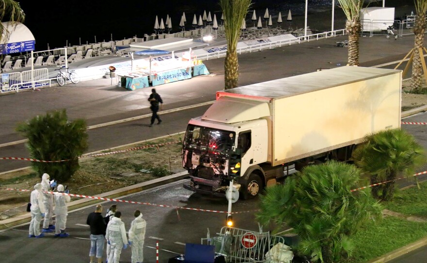 Authorities investigate a truck after it plowed through Bastille Day revelers in the French resort city of Nice on Thursday evening.