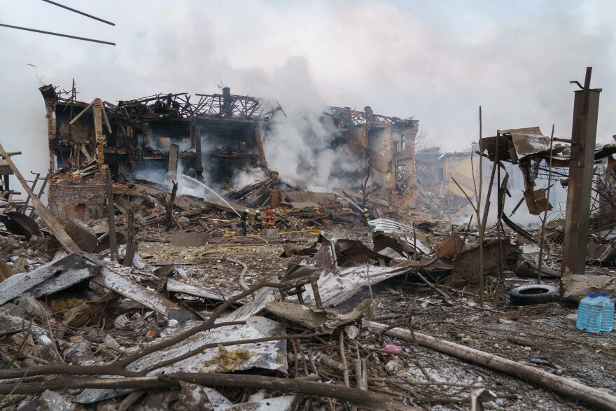 Firefighters spray water on a destroyed shoe factory following an airstrike in Dnipro, in central Ukraine, on March 11. Civilian targets came under Russian shelling that day in what appeared to be the first direct attack on the city. It has otherwise stayed largely safe from the war.